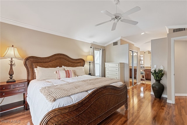 bedroom featuring crown molding, dark hardwood / wood-style floors, and lofted ceiling