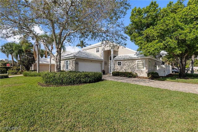 view of front of house featuring a garage and a front yard