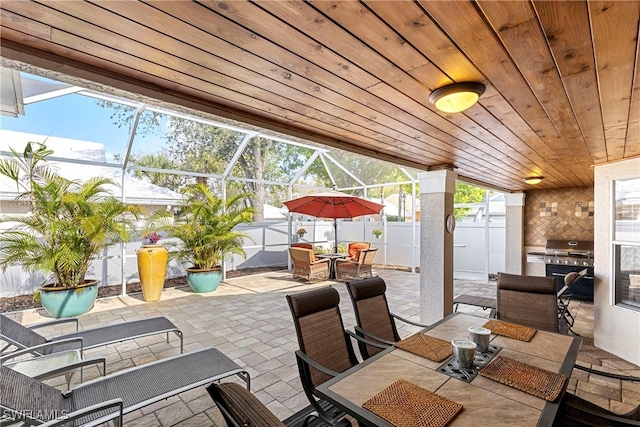 view of patio featuring area for grilling and a lanai