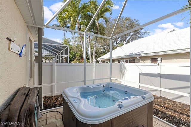 sunroom featuring a jacuzzi