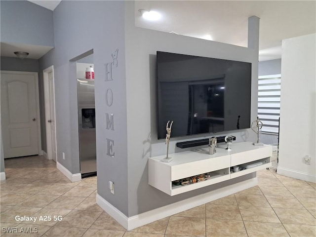 corridor with baseboards and light tile patterned floors