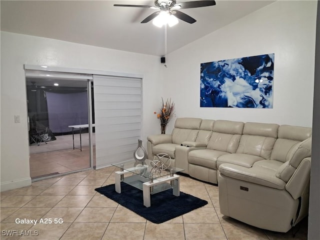 living room with vaulted ceiling, ceiling fan, and light tile patterned floors