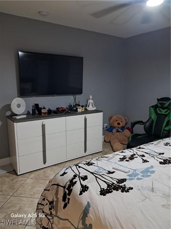 bedroom featuring ceiling fan and light tile patterned floors