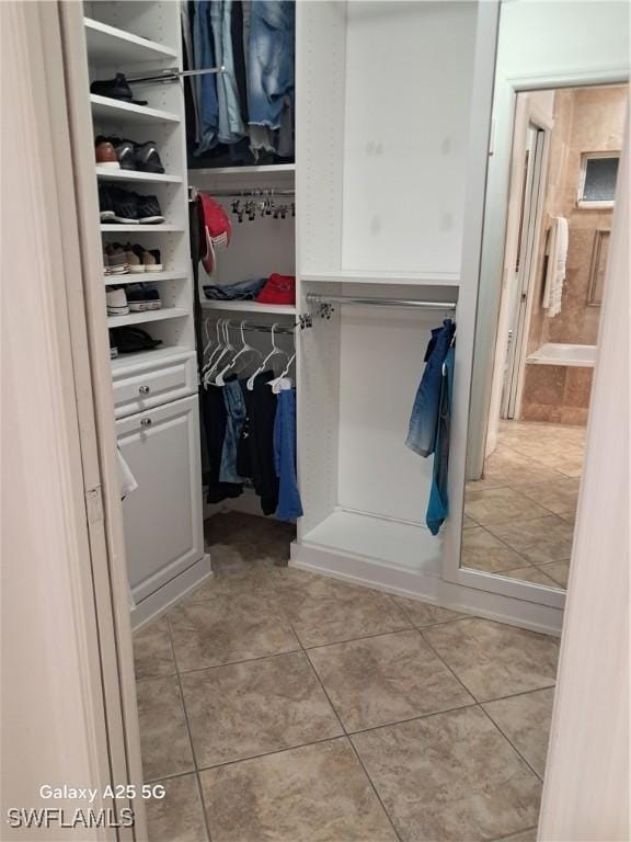 spacious closet featuring light tile patterned flooring