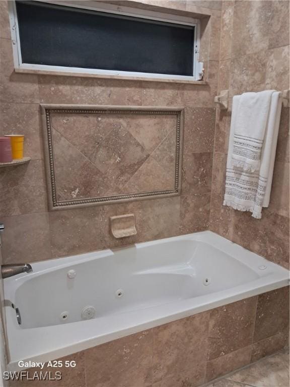 bathroom with tile walls and a relaxing tiled tub