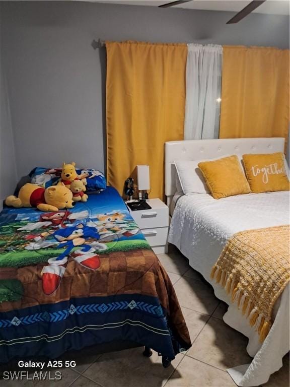tiled bedroom with ceiling fan