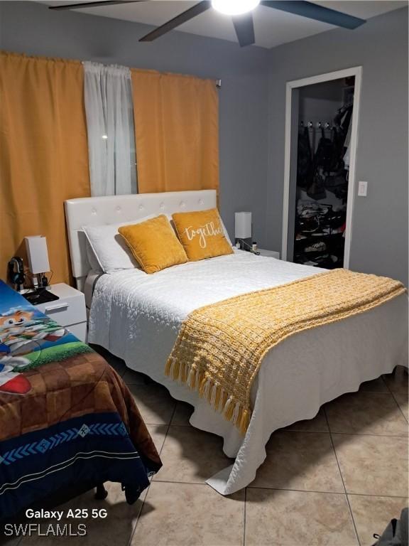 tiled bedroom with a closet and ceiling fan