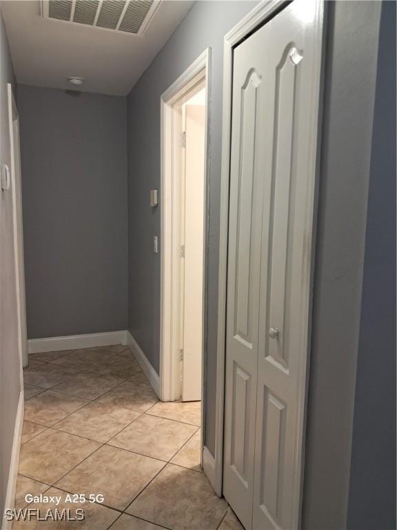 hall with light tile patterned floors