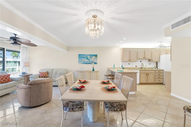 dining room with light tile patterned floors, baseboards, visible vents, and crown molding