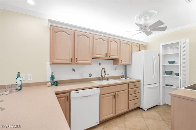 kitchen featuring light brown cabinets, white appliances, a sink, light countertops, and crown molding