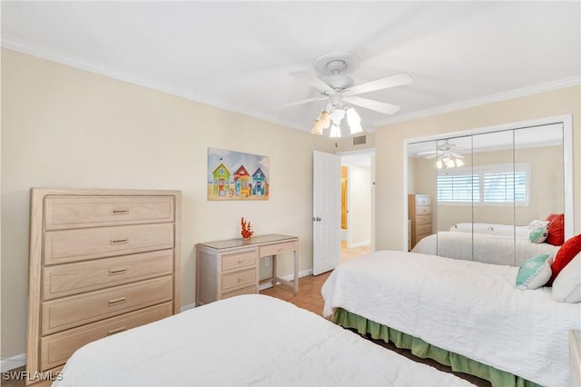 bedroom featuring ceiling fan, a closet, visible vents, and crown molding