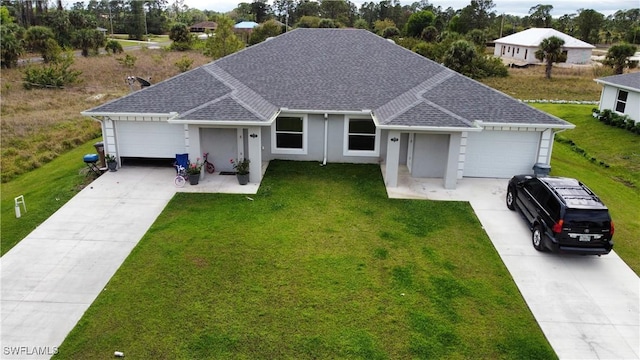 ranch-style home featuring a front yard, concrete driveway, and an attached garage