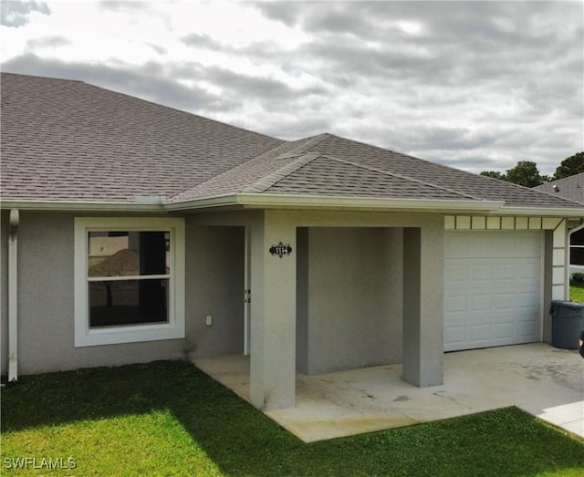 exterior space with stucco siding and roof with shingles