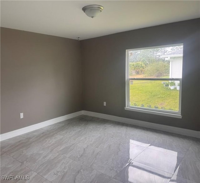 empty room featuring baseboards