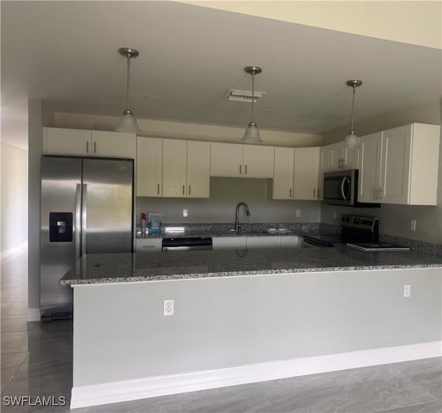 kitchen with pendant lighting, stainless steel appliances, visible vents, dark stone countertops, and a peninsula