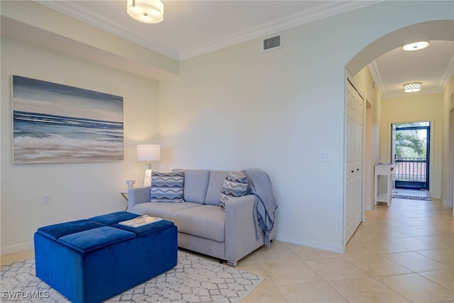 living room with arched walkways, light tile patterned flooring, visible vents, and crown molding