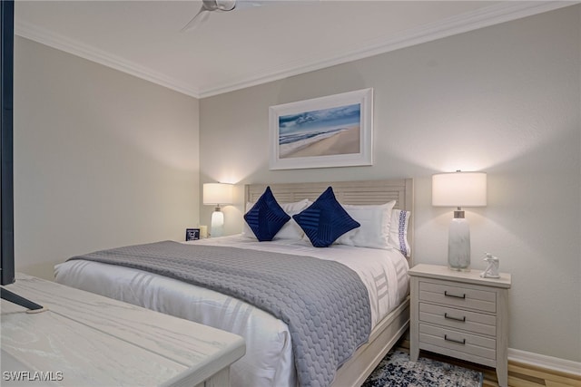 bedroom with light wood finished floors, baseboards, and crown molding