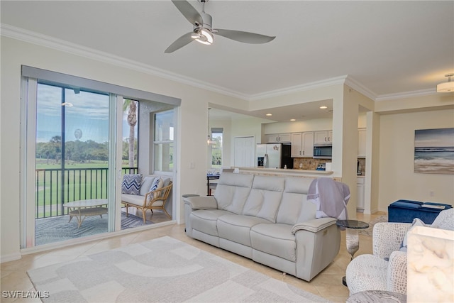 living room featuring baseboards, ornamental molding, a ceiling fan, and light tile patterned flooring