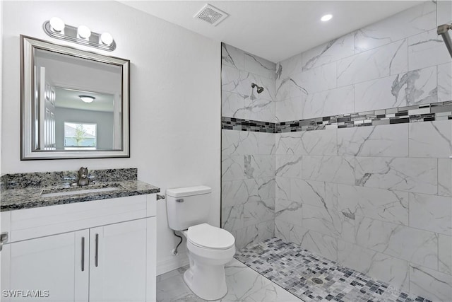 bathroom featuring marble finish floor, visible vents, toilet, vanity, and a shower stall