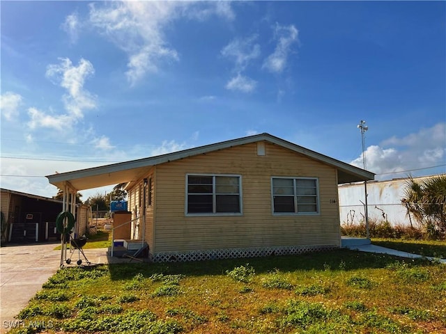 view of property exterior with a lawn