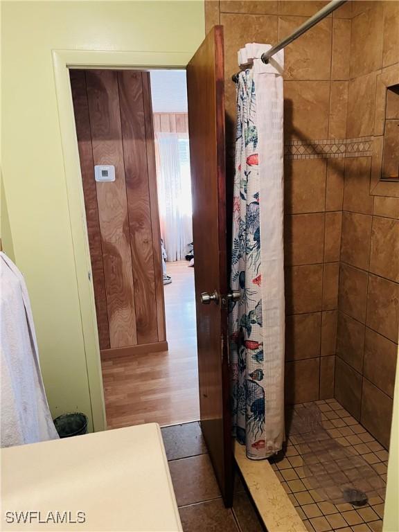 bathroom featuring hardwood / wood-style flooring and walk in shower