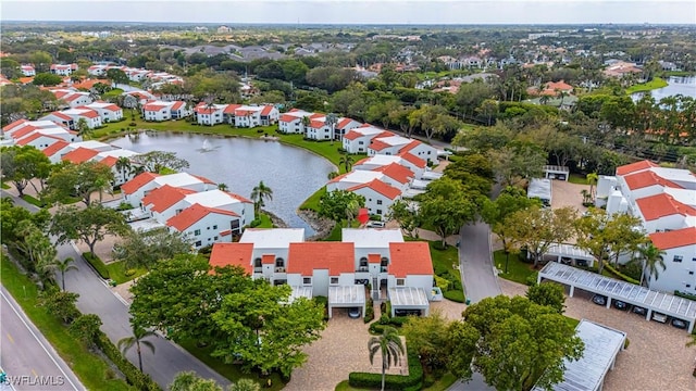 bird's eye view featuring a water view and a residential view