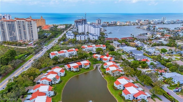 birds eye view of property featuring a water view and a city view