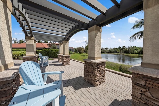 view of patio with a water view and a pergola