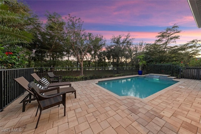 view of swimming pool with fence, a fenced in pool, and a patio