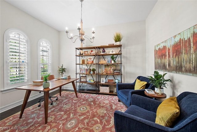 office area with a chandelier, wood finished floors, a healthy amount of sunlight, and baseboards