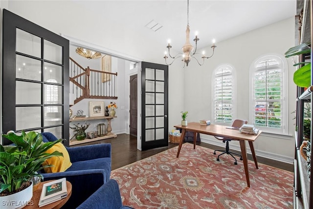 office area featuring a chandelier, visible vents, baseboards, and wood finished floors