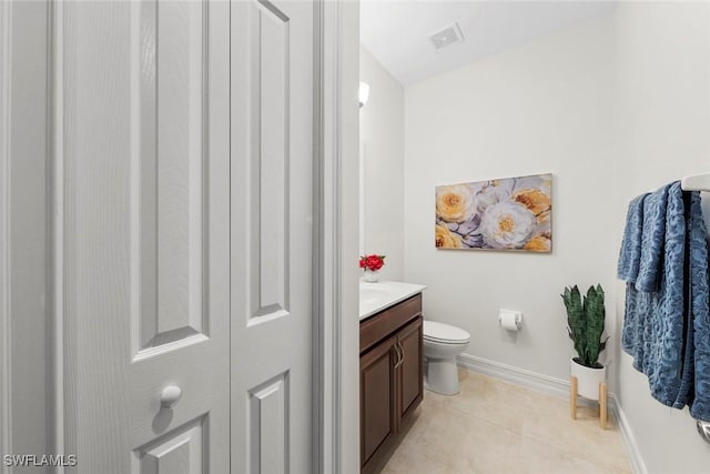 bathroom featuring tile patterned floors, visible vents, toilet, vanity, and baseboards