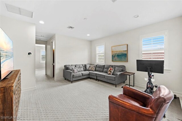 living room with carpet floors, recessed lighting, visible vents, and baseboards