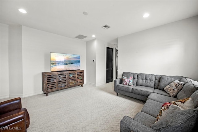 living area with recessed lighting, visible vents, and light colored carpet