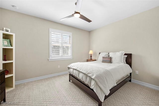 carpeted bedroom featuring ceiling fan and baseboards