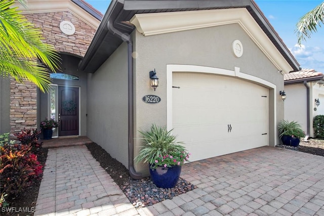 garage featuring decorative driveway