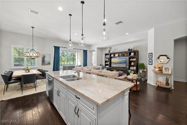 kitchen featuring dark wood-style floors, visible vents, light stone counters, and a sink