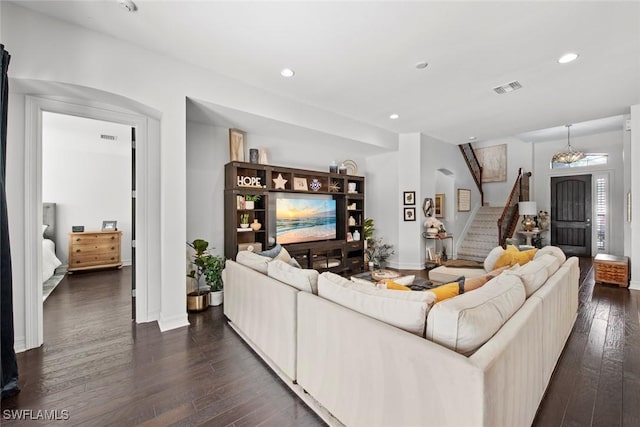 living room featuring dark wood finished floors, stairs, visible vents, and recessed lighting