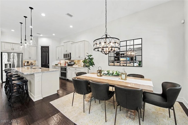 dining space with a notable chandelier, visible vents, dark wood-style floors, and recessed lighting