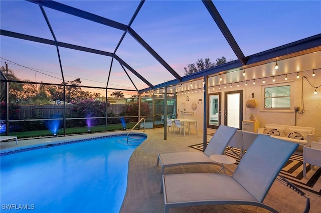 pool at dusk featuring glass enclosure, a patio, a fenced backyard, and a fenced in pool