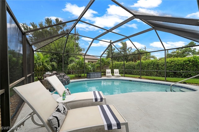 outdoor pool with a lanai and a patio