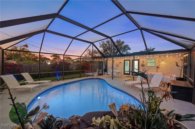 view of swimming pool with a fenced in pool, a patio area, glass enclosure, and fence