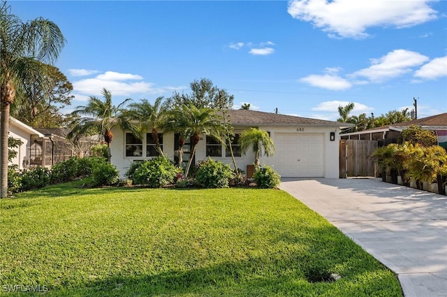 ranch-style home featuring driveway, an attached garage, a front yard, and stucco siding