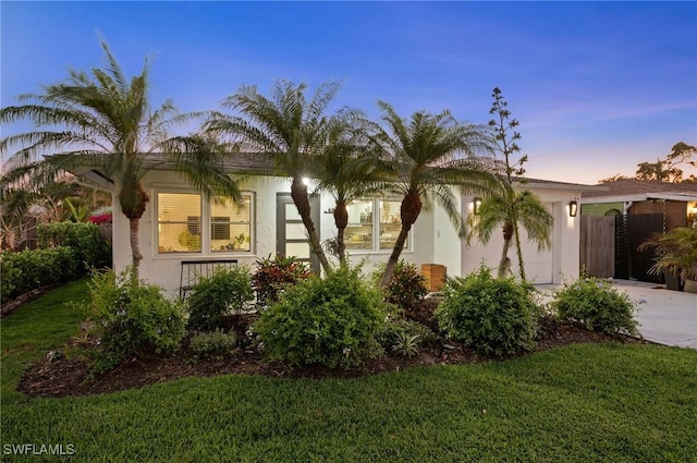 view of front facade featuring a yard and stucco siding