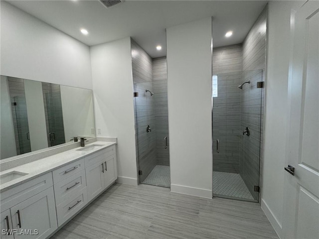 3539 NE 14th Pl, Cape Coral, FL 33909 - full bath with baseboards, a shower stall, double vanity, recessed lighting, and wood finished floors