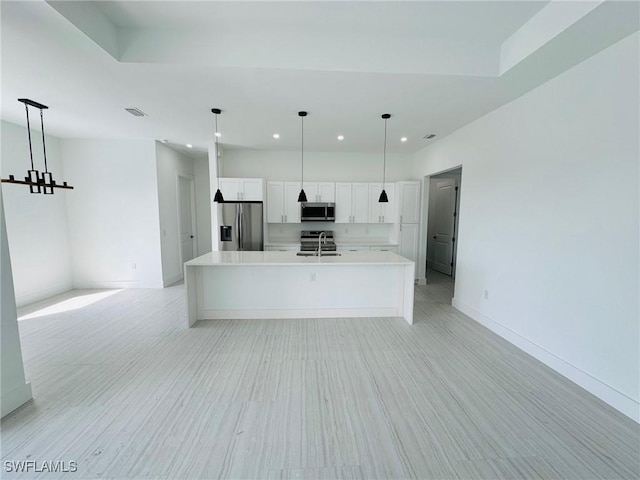 3539 NE 14th Pl, Cape Coral, FL 33909 - kitchen with stainless steel appliances, light countertops, recessed lighting, a large island with sink, and white cabinets