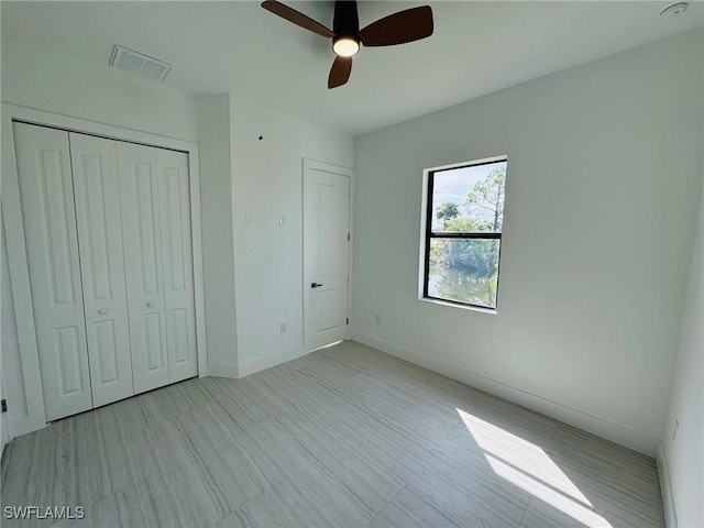 unfurnished bedroom with a closet and ceiling fan