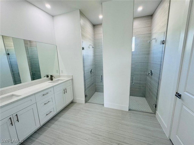 bathroom with vanity and a shower with shower door