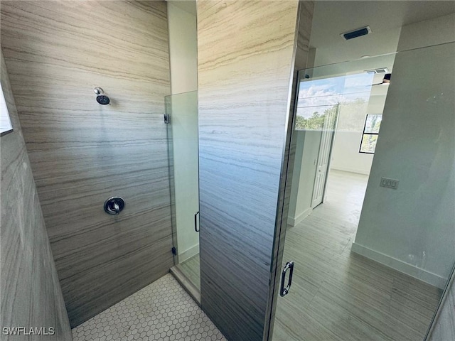 bathroom featuring a shower with door