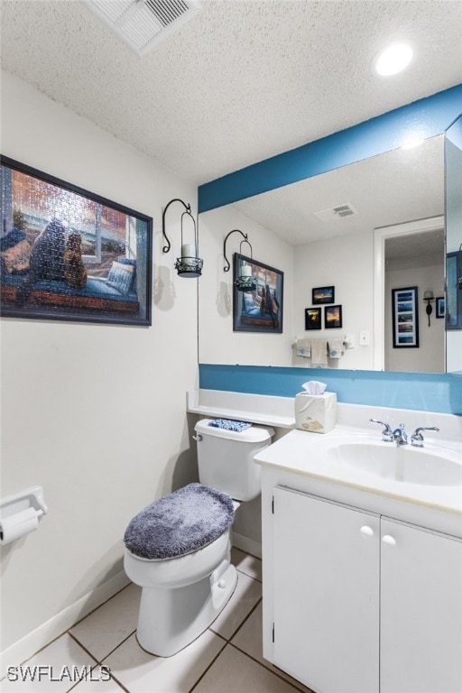 half bathroom with a textured ceiling, toilet, visible vents, vanity, and tile patterned floors